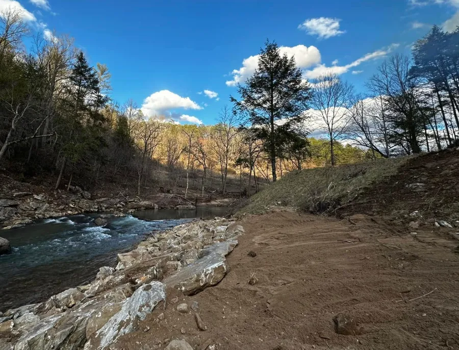 Creek bank rebuilt with rock after storm damage