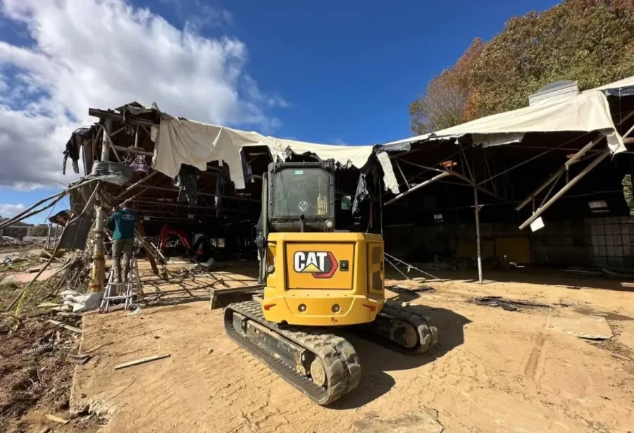 Demolition debris being cleared by excavator