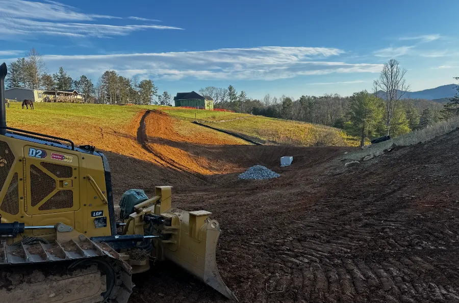 Dozer grading a homesite with mountain views behind it