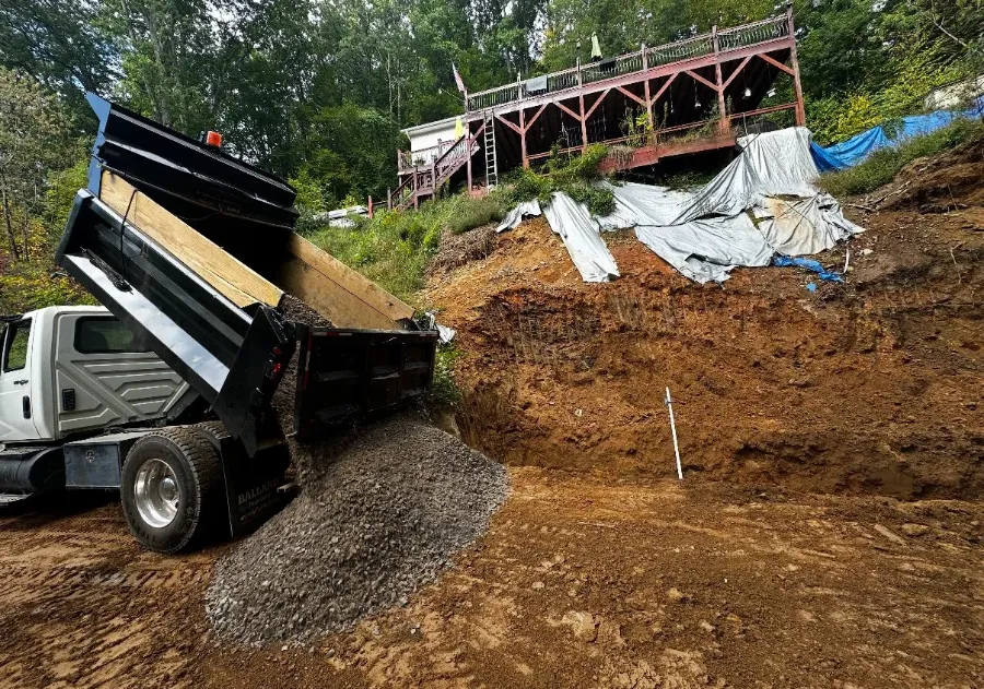 Dump truck spreading gravel on a site
