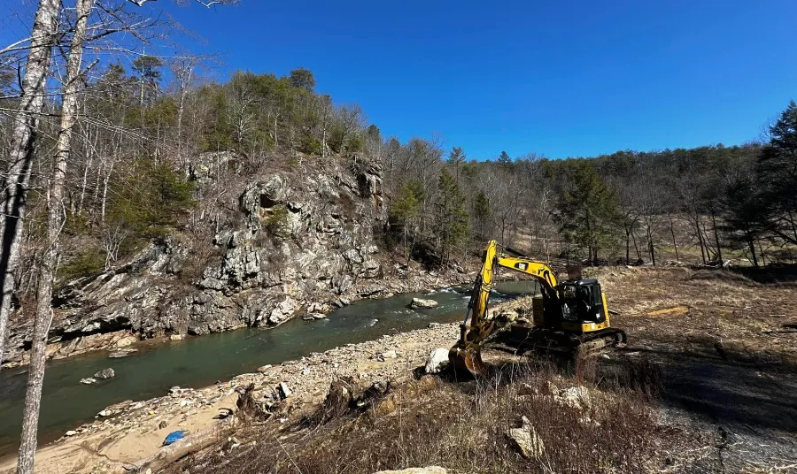 Excavator in a rocky river gorge
