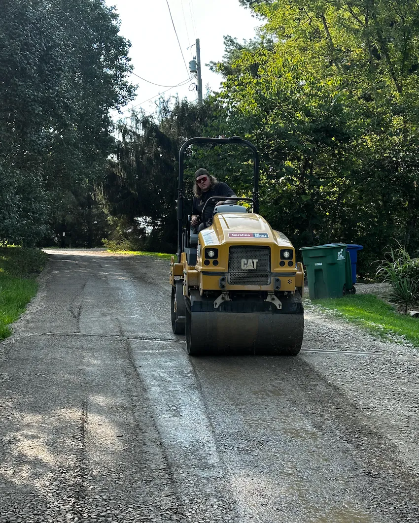 Roller compacting a driveway