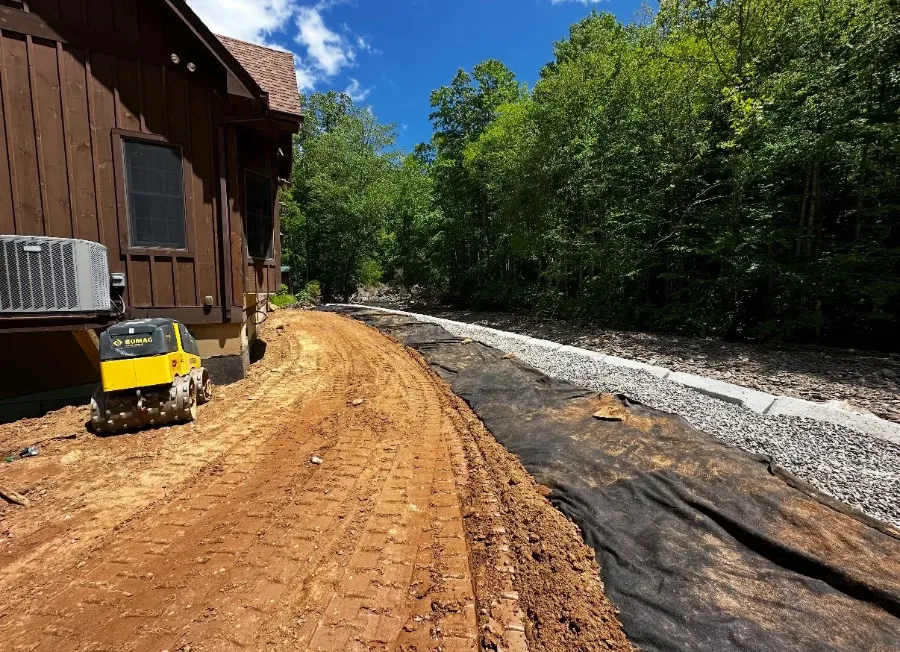 Freshly graded slope beside a mountain home